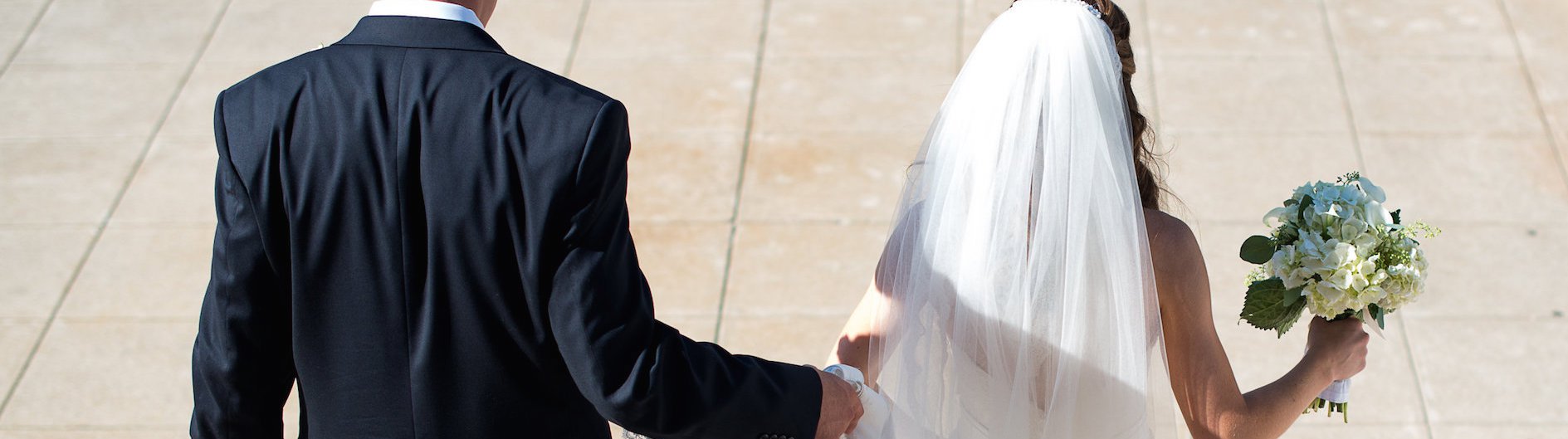 Bride and Groom Walking Holding Hands