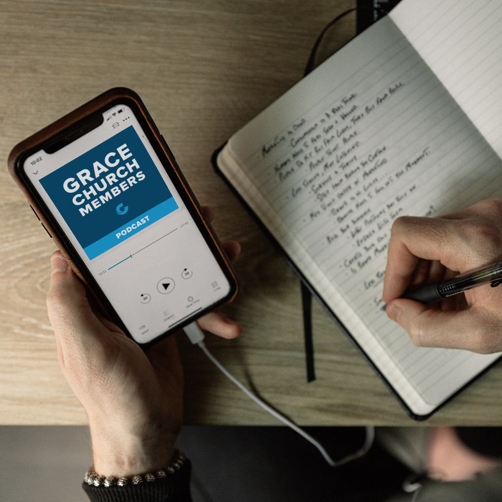 Grace Members Podcast Playing on Phone next to Notebook
