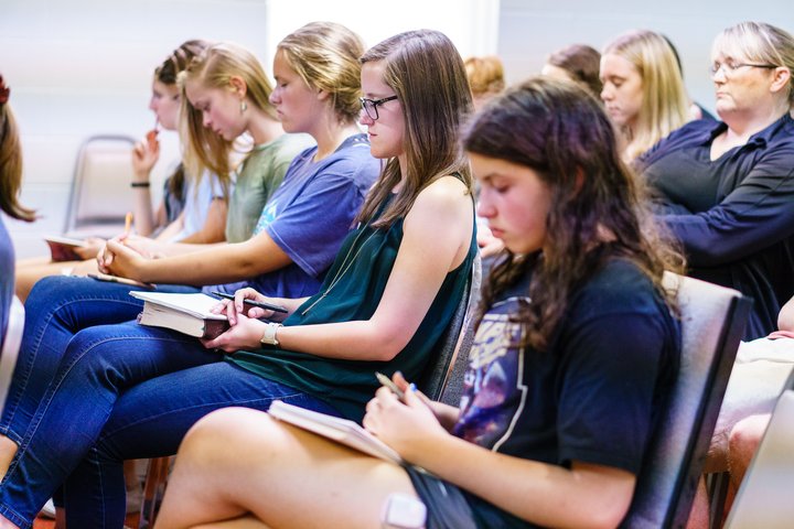 Women Sitting in Service