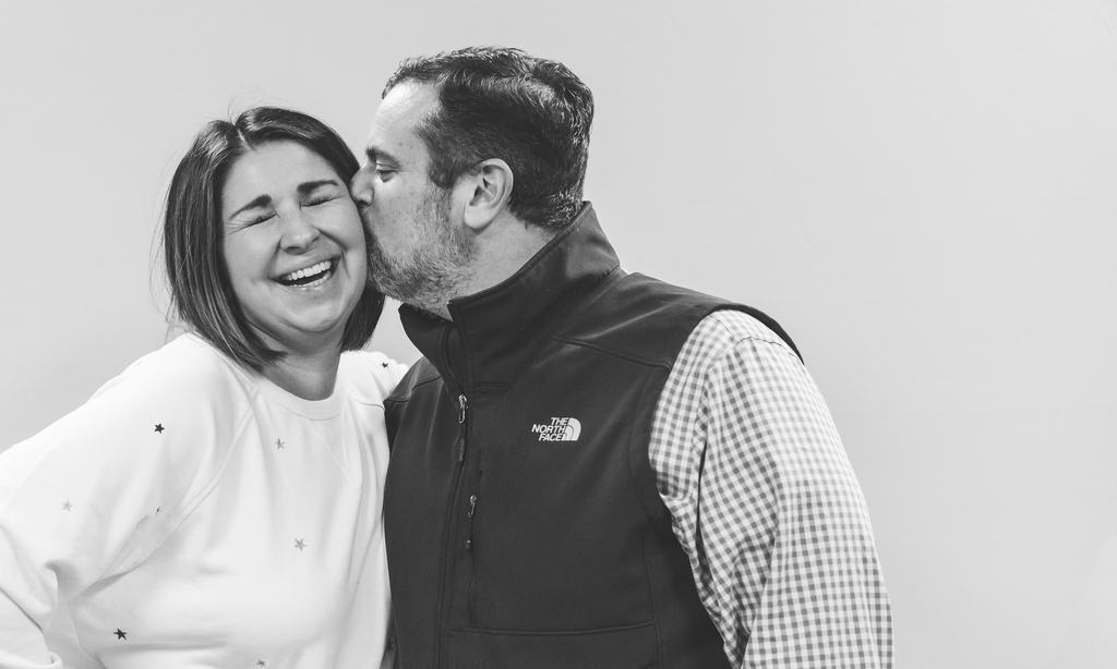 Man kissing wife on the cheek