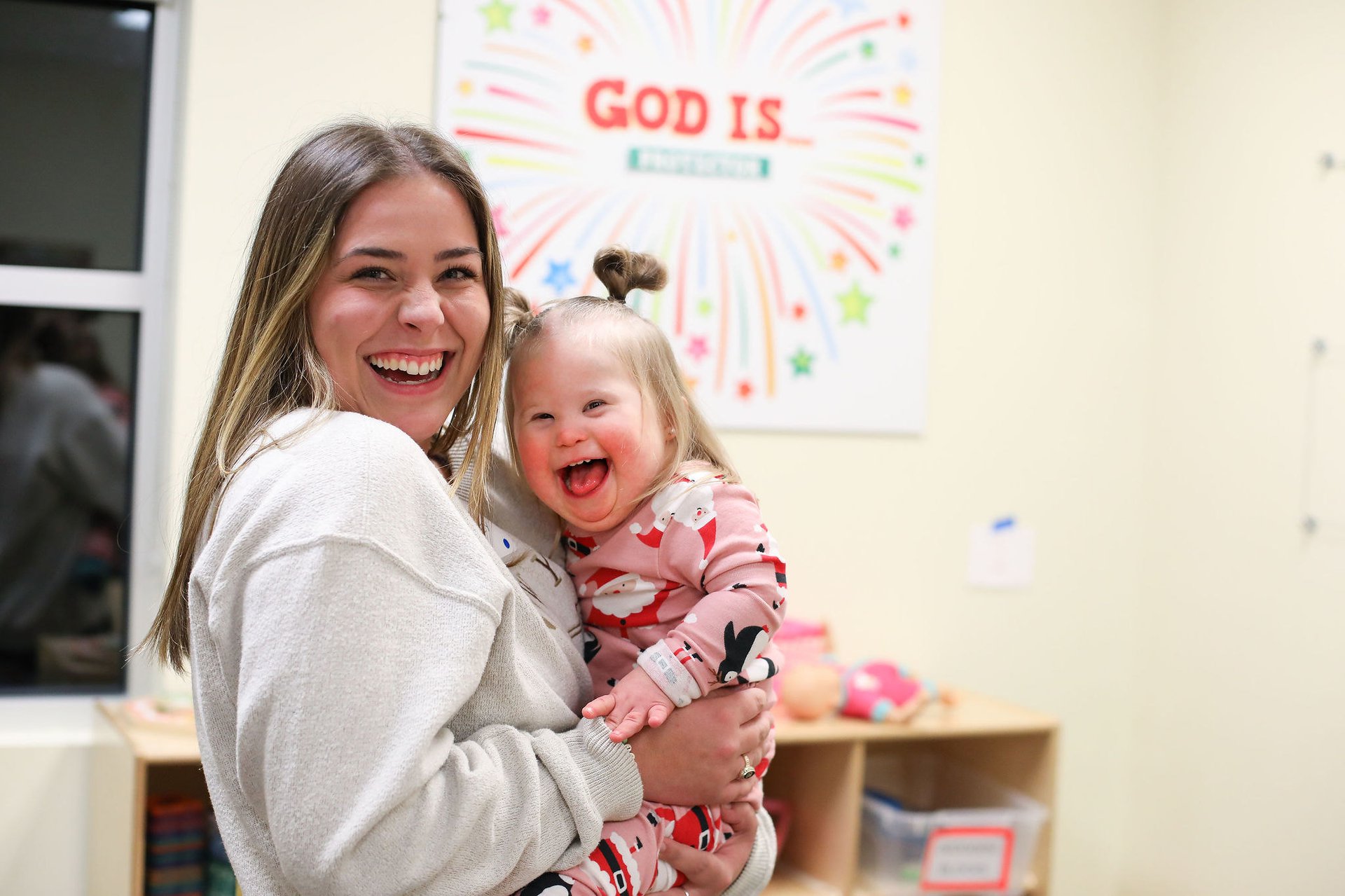 Mosaic women and girl with special needs smiling