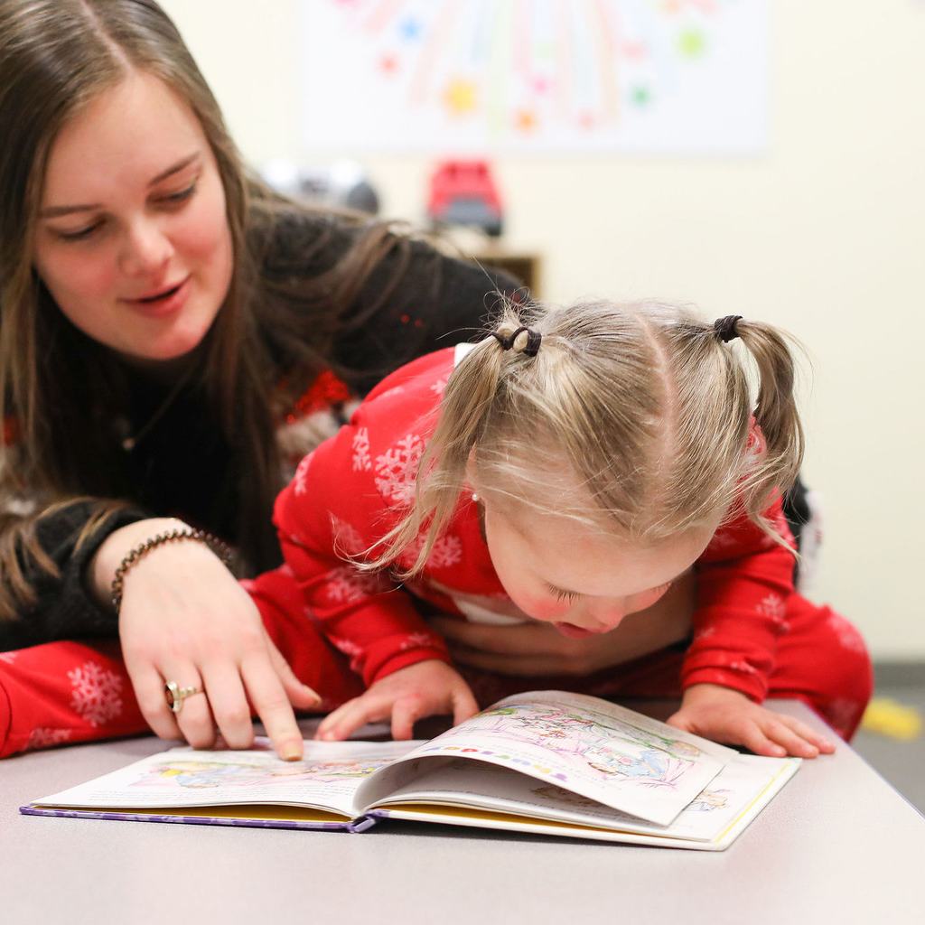 girl with special needs reading book