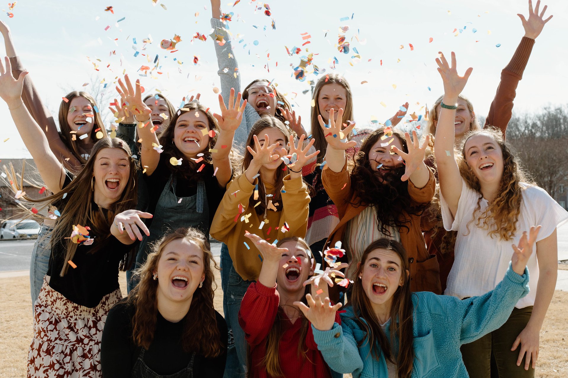 female students throwing confetti