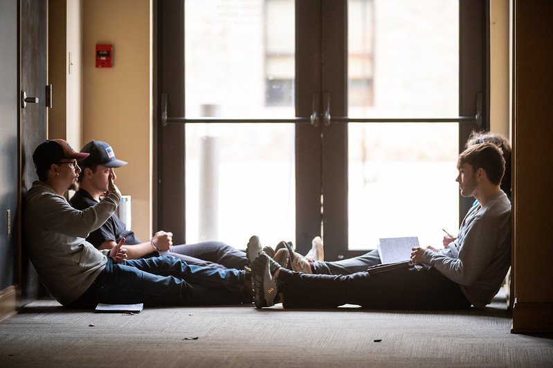 Men Having Discussion in Hallway at Forge Winter Weekend