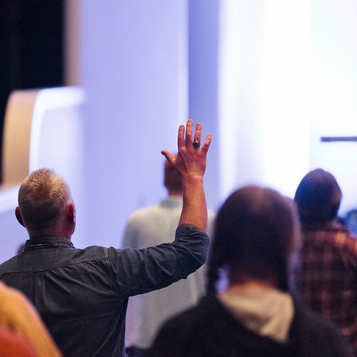 Man worshipping with his hand up