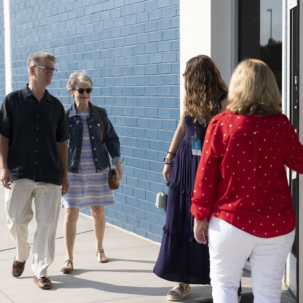 Greeters welcoming couple