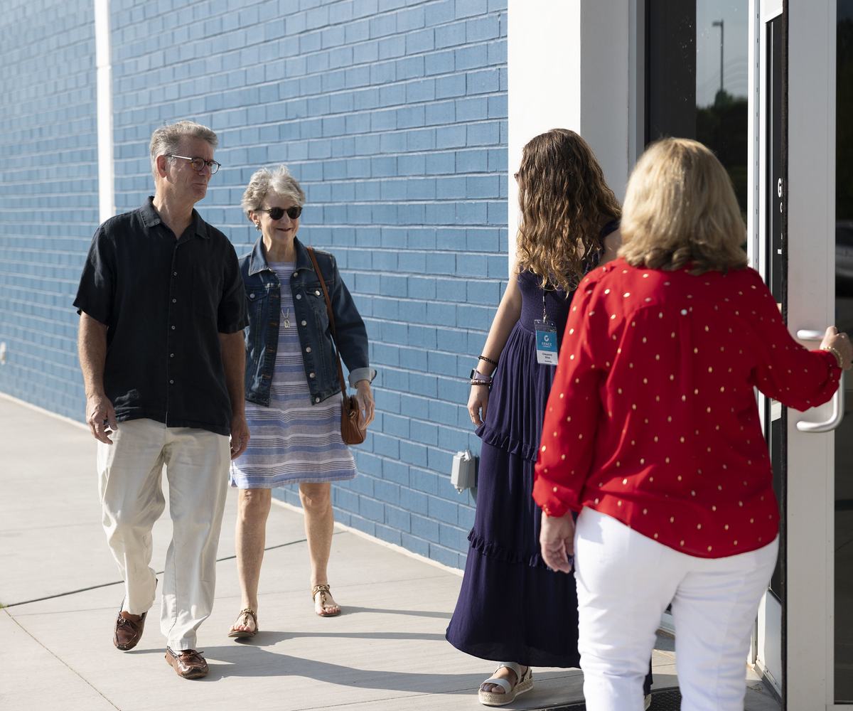 Greeters welcoming couple