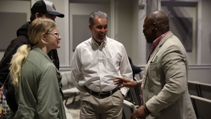 Pastor talking with members