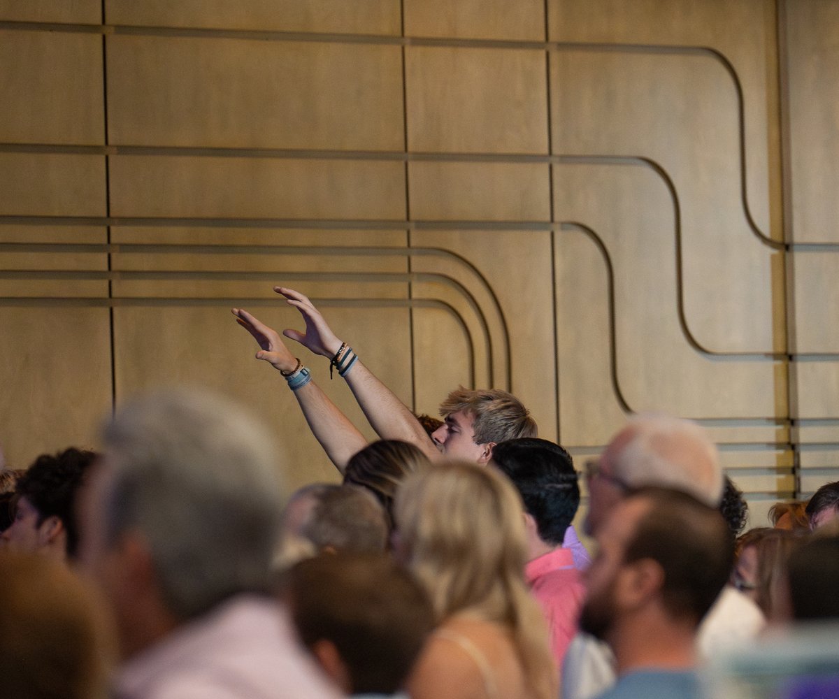 Man raising hands in worship service