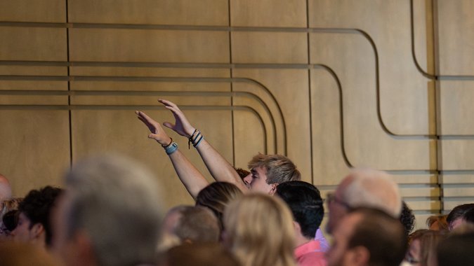 Man raising hands in worship service