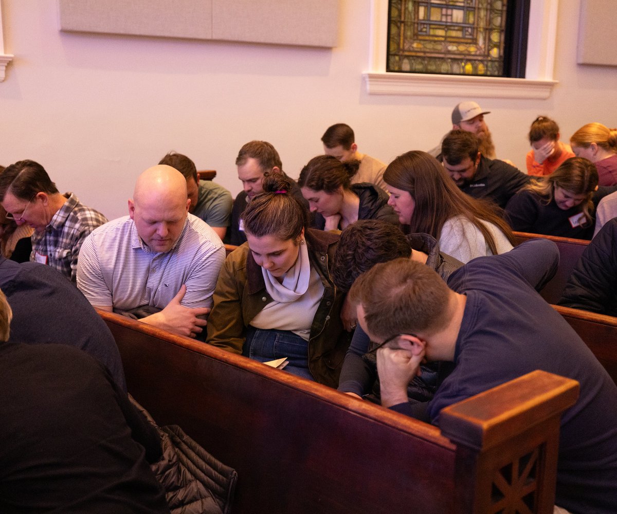 Congregants praying together in pews