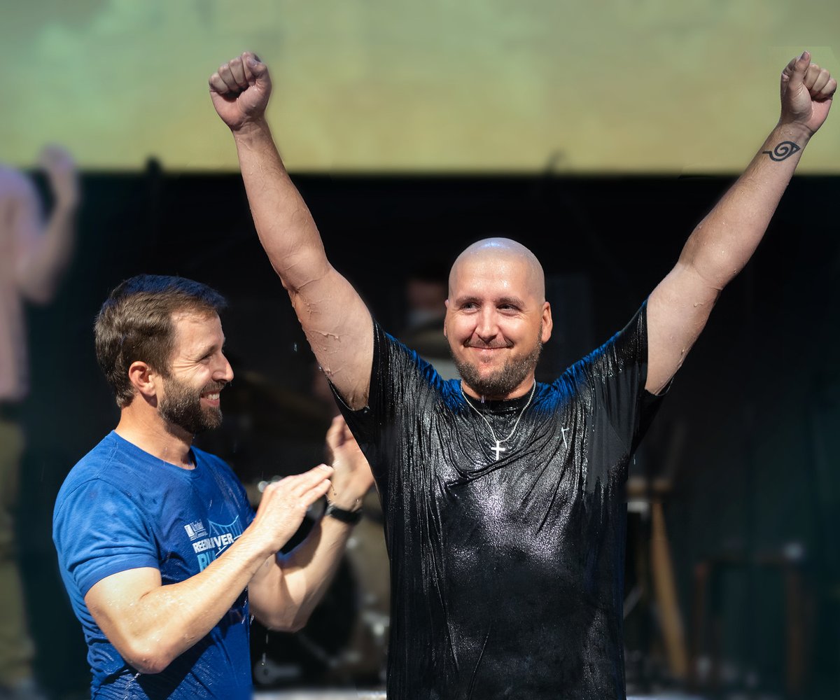 Man raising arms after baptism