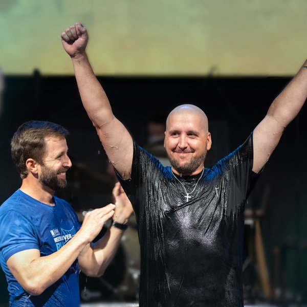 Man raising arms after baptism