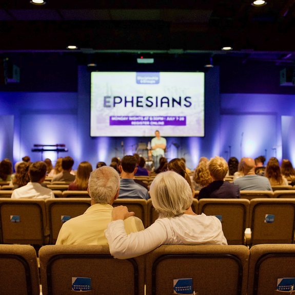Couple sitting together in service