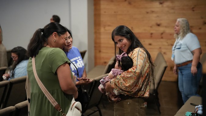 Women smiling with mom holding baby