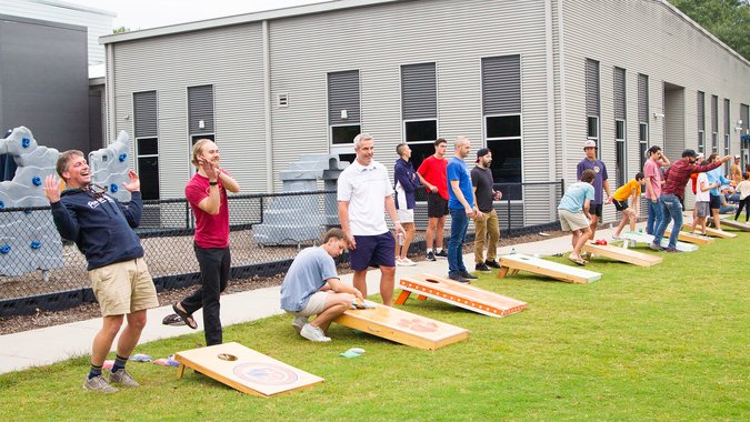 Players participating in cornhole tournament
