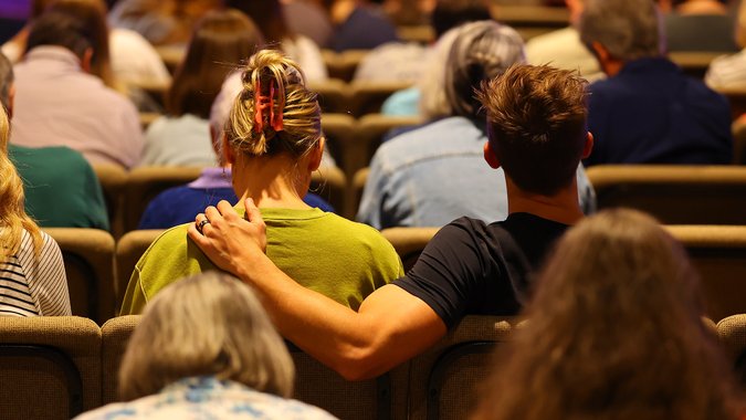 Couple sitting together in service