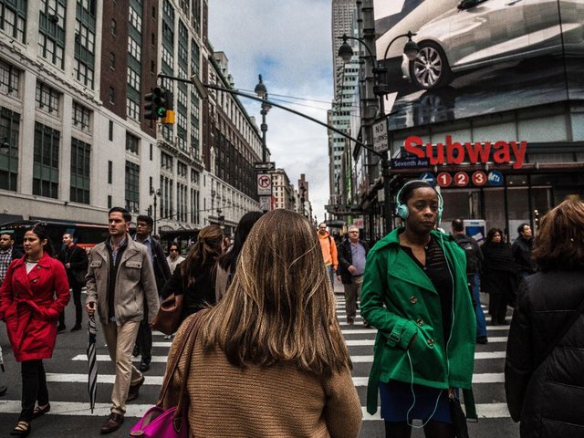People Walking Across Crosswalk in City