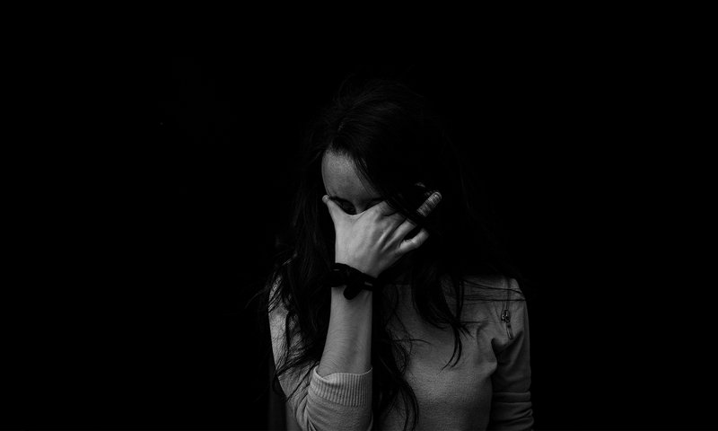 Woman Covering Face with Hand