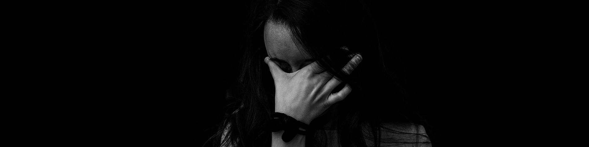 Woman Covering Face with Hand