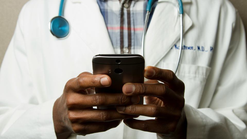 Doctor Looking at Phone