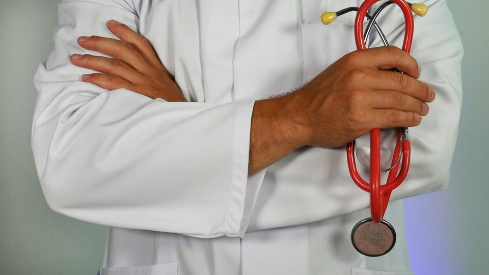 Doctor's arms crossed with stethoscope