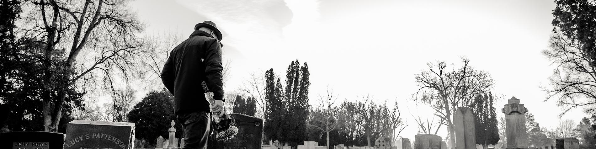 Man Taking Flowers to Grave